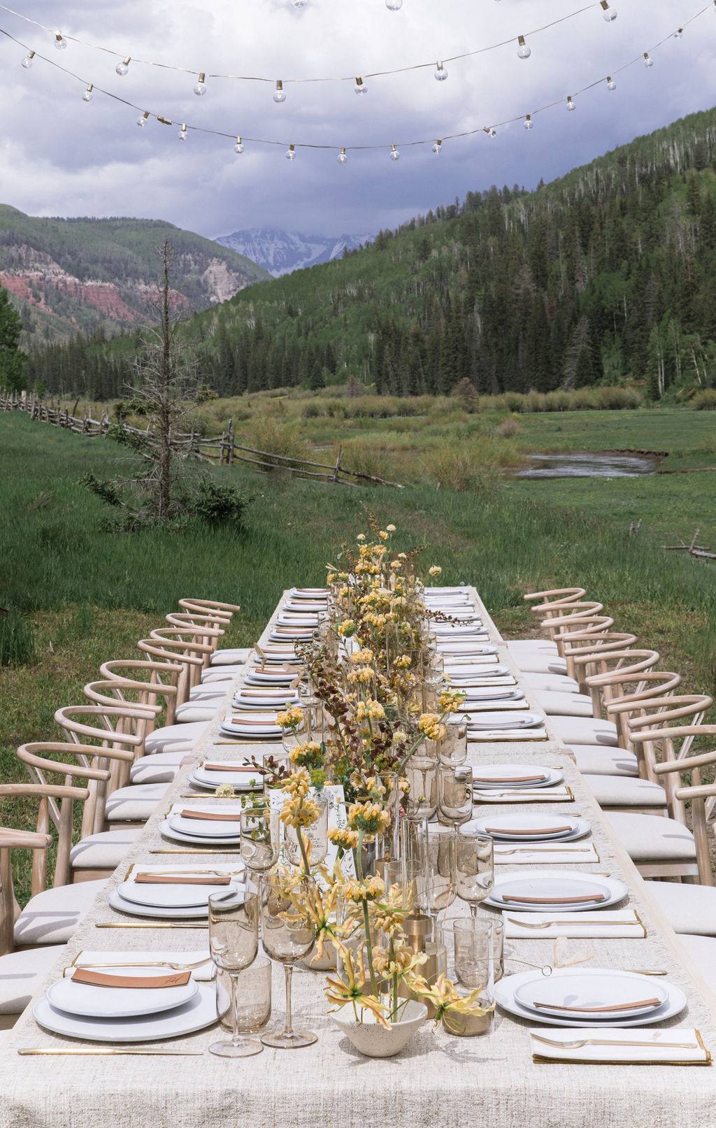 Long table set in a mountain meadow at Dunton Hot Springs